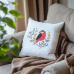 A khaki-colored blanket and a white bird embroidery pillow on the sofa