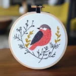 Close-up Handcrafted Bird and Branch Embroidery Artwork