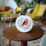 Handcrafted Bird and Branch Embroidery Artwork Placed on the Table
