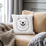 A smiling Samoyed embroidery pattern stitched on a pillowcase, placed on a sofa.