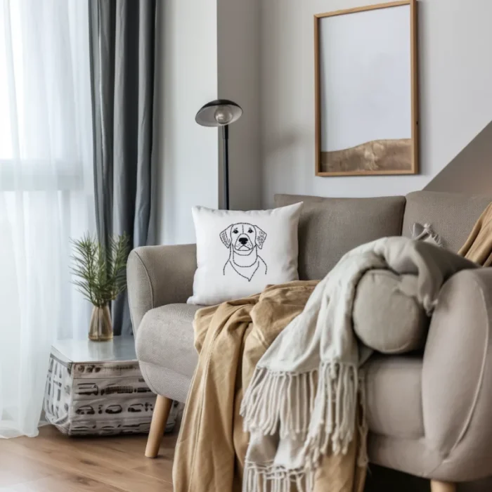 A sad puppy embroidered throw pillow in a modernly decorated living room, adding a touch of elegance to the space.