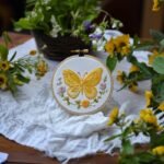 yellow butterfly embroidery placed on the table