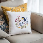 A bright setting with a beige sofa adorned with delicate embroidered pillows