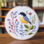 Close-up of a colorful bird and floral embroidery design