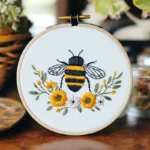 Close-up of bee and chrysanthemum flower embroidery design