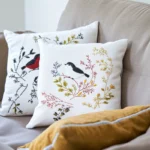 Elegant and delicate embroidered cushion styled on a light gray sofa