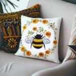 Two colorful embroidered pillows placed on a light gray sofa