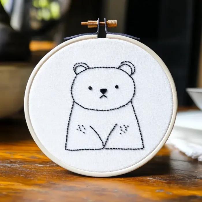 Close-up of a cute and gentle minimalist bear embroidery design