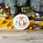 Fox embroidery artwork with yellow leaves and a small potted plant