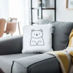 Sofa with a white cushion and a yellow-and-white blanket