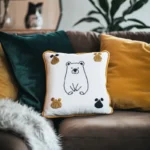 Sofa with several cushions, one of which features a cute bear design