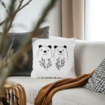 Bright room with a gray sofa, a gray cushion, a white bear embroidery pillow, and a brown throw blanket