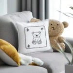 Gray sofa with a white fabric bear embroidery pillow and a small bear knit toy