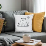 Dark gray sofa with two pillows—one in earthy yellow and one with white bear embroidery