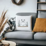 Gray fabric sofa with a white bear embroidery pillow and an earthy yellow cushion
