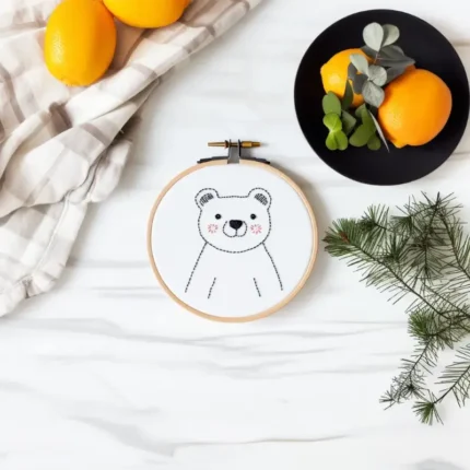 Smiling bear embroidery with rosy cheeks placed in the center, decorated with lemons on a plate