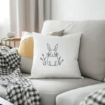Gray sofa with a black-and-white checkered blanket and a white rabbit embroidery pillow