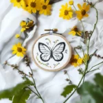 butterfly artwork stitched using a digital embroidery pattern, displayed on table