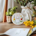 Cozy work table with hand-embroidered rabbit and small potted plant