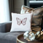 gray sofa with a soft flannel cushion and a white butterfly embroidery pillow