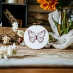 table with fresh flowers and a delicate butterfly embroidery design