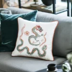 Gray sofa with a green pillow and a white pillow, creating a cozy and comfortable look