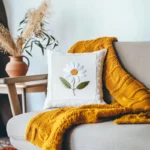 bright and cozy room with sofa cushions and a knitted blanket