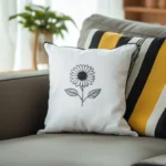 bright room with a gray sofa, a white sunflower cushion, and a striped pillow