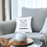 bright room with a gray sofa featuring an owl embroidery pillow
