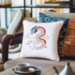 chair with two cushions, one featuring a dragon embroidery design