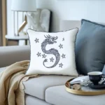 Cozy sofa with two cushions, a blanket, a book, and a cup of coffee