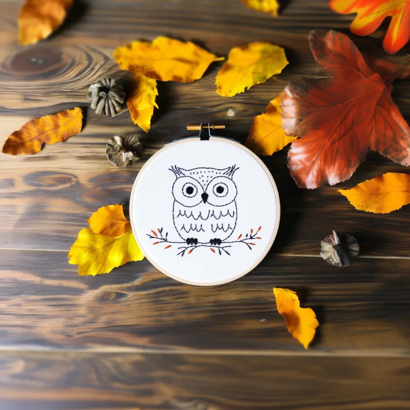 cute owl hand embroidery on fabric, secured in an embroidery hoop with decorative leaves cute owl hand embroidery on fabric, secured in an embroidery hoop with decorative leaves