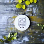 cute owl hand embroidery piece placed on the floor