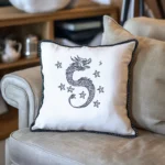 Gray sofa with a gray cushion and a white cushion featuring dragon embroidery