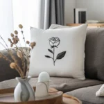 gray sofa with a white rose embroidery pillow and a small table with decorations in front
