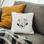 gray sofa with two cushions, creating a cozy and inviting atmosphere