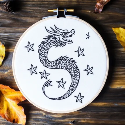 hand embroidery artwork of a dragon flying across the starry sky