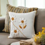 sofa with two cushions and a bouquet of flowers, creating a relaxing and pleasant atmosphere