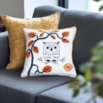 sofa with two decorative pillows, one gold and one white, both stylish and unique