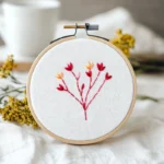 a clean piece of fabric embroidered with a red and yellow flower