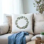 a floral wreath embroidered pillow on the sofa next to a blue dress