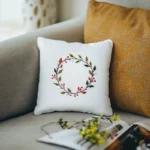 a small white pillow placed in front of a larger orange cushion