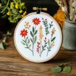colorful floral embroidery piece standing upright on a table