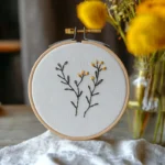 hand-embroidered wildflower design with yellow blossoms and green leaves