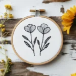 hand-embroidered wildflowers stitched with black thread, featuring two flowers