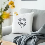 light gray sofa with a white pillow and a gray blanket for a cozy feel