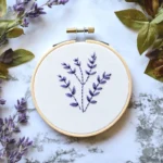 purple wildflower embroidery artwork displayed on a table