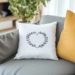two cushions on the sofa with an indoor green plant in the background
