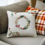 white embroidered pillow and a plaid cushion placed on the sofa
