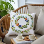 white pillow on a chair embroidered with a double-ring floral wreath